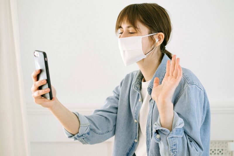 woman in face mask having video call